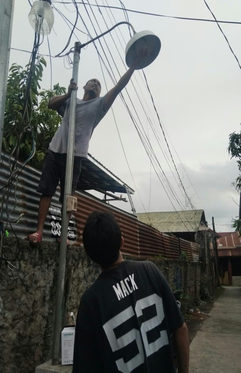Replacing a streetlight along an alley